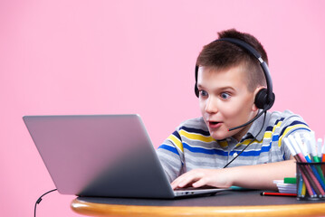 Young teenage boy attending an online class or working on his homework