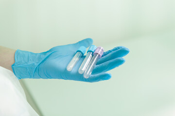 empty blood sampling tubes lie on the nurse's palm