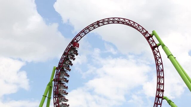 people ride on roller coaster