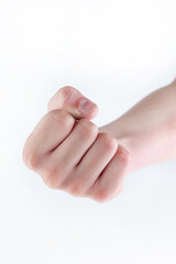Boy's fist on a light background. The concept of aggression.