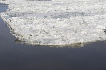 Iceberg on a river in winter. Cold and icy. Iceberg and winter background. Abstract background. Ice reflection on water.