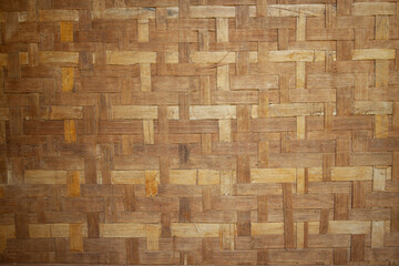 The background wall of the house is made of woven bamboo.