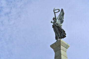 Metal statue "La Libertatd / Liberty" on a podium (Talca, Chile).