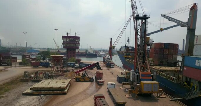 Heavy Equipment Machinery Loading Cargo Vessel Docked At Mangalore Port In India. - aerial

