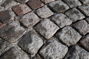 Obraz premium Abstract background of an old cobblestone pavement . Close up view