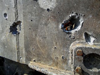 tank armor slashed by shrapnel from a wrecked tank, close-up