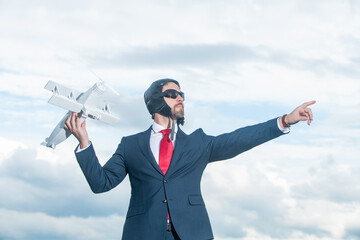 boss in suit and pilot hat launch plane toy