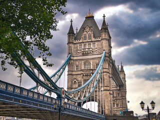Fototapeta na wymiar Looking up at the Tower Bridge in London England shrouded in rain clouds 