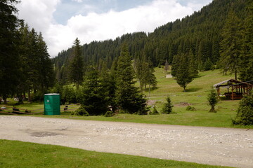 toilet wc near trail mountain trees side