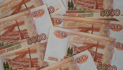 Largest bill of Bank of Russia. Russian paper banknotes with nominal value of five thousand rubles close-up view from above. Economics and finance of Russian Federation.