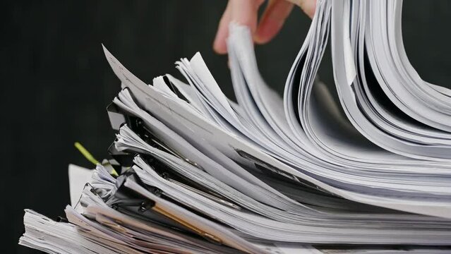 Businessman are searching for documents lying on the table, business report papers, important documents.