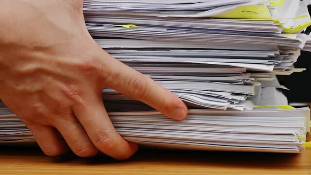Businessman are searching for documents lying on the table, business report papers, important documents.