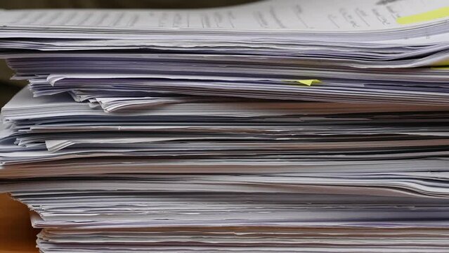 Businessman are searching for documents lying on the table, business report papers, important documents.