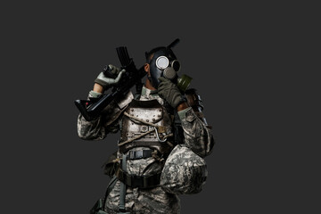 Studio shot of black army soldier dressed in protective gas mask and camouflage clothes.