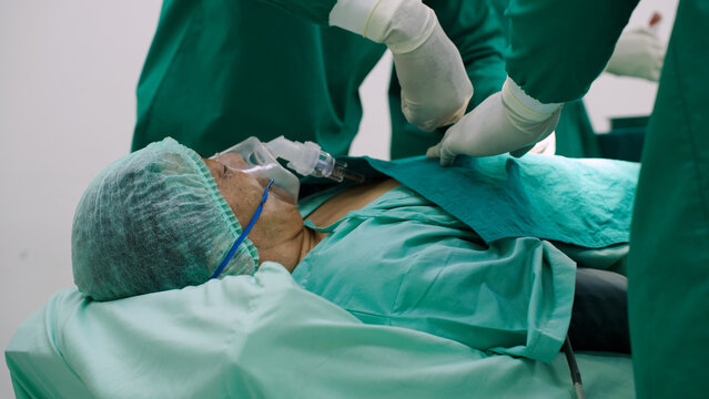 Asian senior man undergoing heart surgery in the operating room