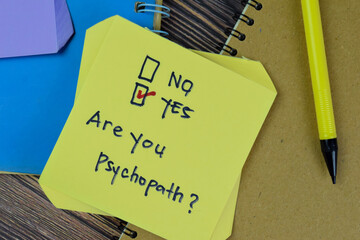 Concept of Are you Psychopath? Yes write on sticky notes isolated on Wooden Table.