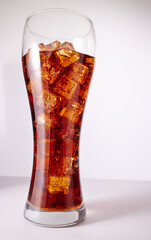 cola with ice cubes on white