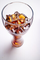 cola with ice cubes on white