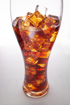 cola with ice cubes on white