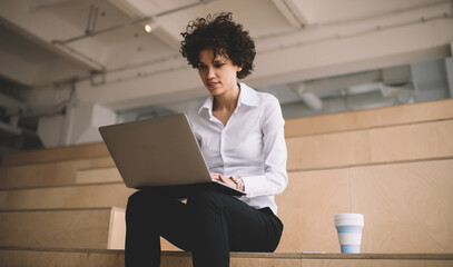 Millennial girl working in coworking office space