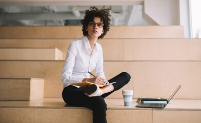 Millennial girl working in coworking office space