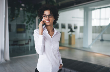 Business woman talking on smartphone in office