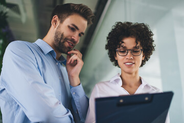 Millenial business man and woman working in office