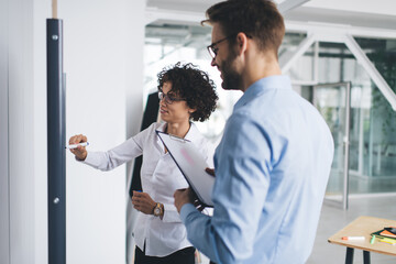 Business man and woman work at interactive board