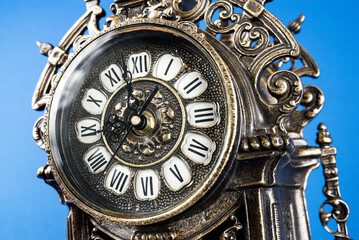 Fototapeta na wymiar dial of vintage bronze clock, antique clock photo close up, old bronze clock in gilding, front of bronze fireplace clock