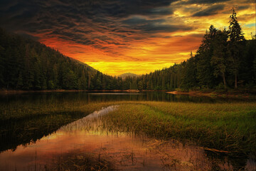 Lake in the mountains, at sunset with reflections