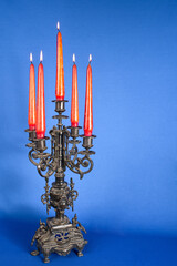 Fototapeta na wymiar classic bronze chandelier with burning candles, ancient candlestick studio photo, antique candlestick isolated, brass chandelier, one vintage candlestick, bronze candle tree with candles
