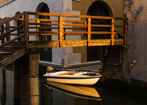 old wooden bridge and boat in Venice, Italy 
