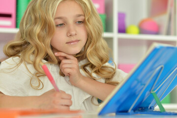 cute little girl studying at home