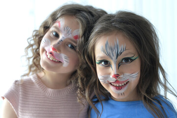 Cute little girls with faces painted smiling