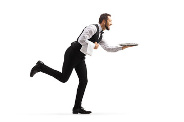 Full length profile shot of a waiter running with an empty tray