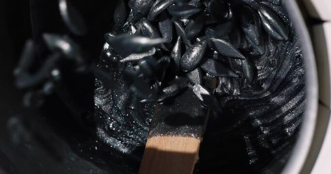 Preparation of black wax for shugaring. Close-up wax for depilation.