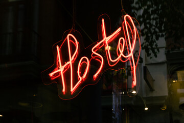 Photograph of a red neon sign on which you can read the word 
