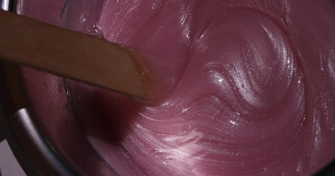 Preparation of pink wax for shugaring. Close-up wax for depilation.