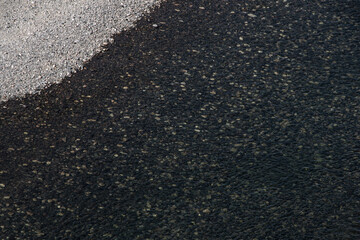 View of river bottom as background. Clear water allows to see stones and branches. Observation of underwater world