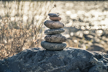 Balancing stone on shore. Balance of scales. Harmony in decision making Balanced stones on top of boulder. Peace of mind balance for meditation.