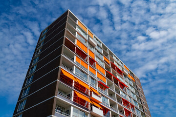Block of Flats appartment house in Rotterdam Netherlands with Balconys, windows and orange awnings....