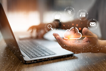 Online data collection technology concept, Man use laptop woking and keep data in Cloud storage technology for data security from damage and holding a smartphone in blur background