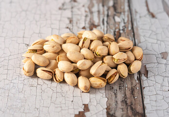 Pistachio nuts on a cracked wooden background