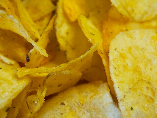 Spiced potato chips, a close-up shot. Fried potatoes.