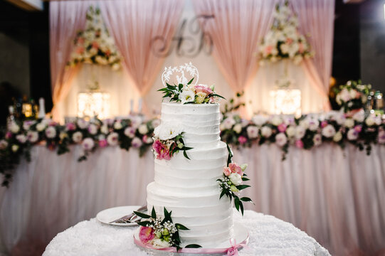 White wedding cake with pink flowers for wedding banquet. Delicious reception. Copy space. Celebration party concept. Trendy Cake.