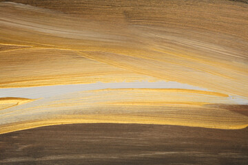 Fototapeta premium Beige, brown and gold color smear brushstroke painting. Art Abstract copy space empty wall background.