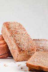 Freshly baked bread with sesame seeds on a white background.