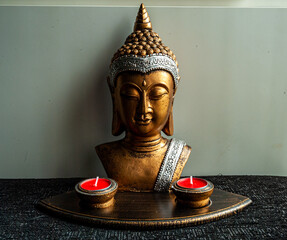 Buddha bust with candles