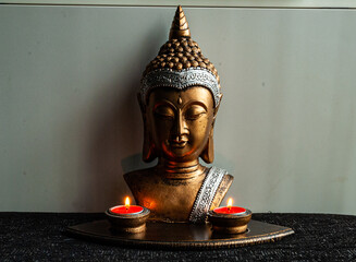 Buddha bust with candles