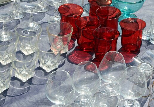 collection of rare very fragile glass glasses and red vintage style liqueur goblets for sale in flea market